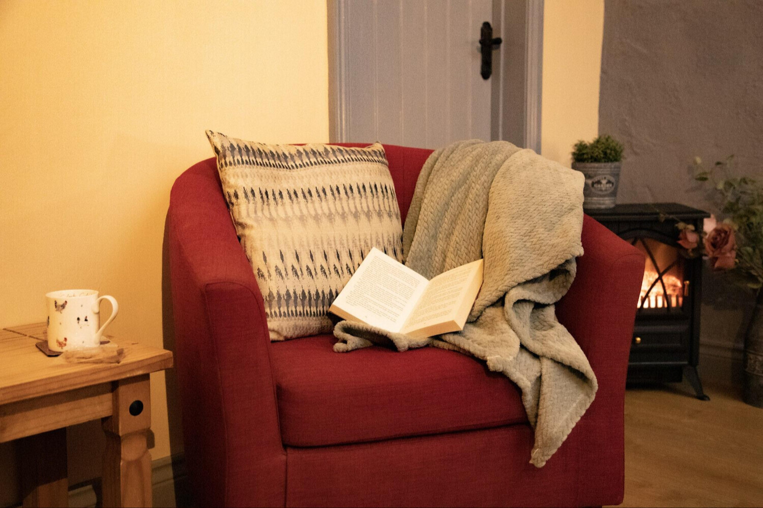 A cosy chair, blanket, and a good book by the fire