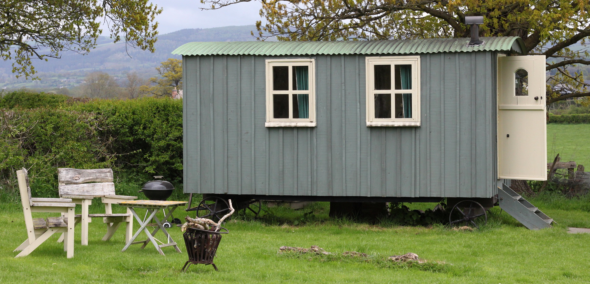 Traditional shepherd's hut with a hilly backdrop