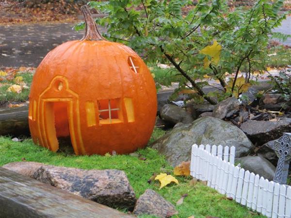 A pumpkin carved into a house for Halloween