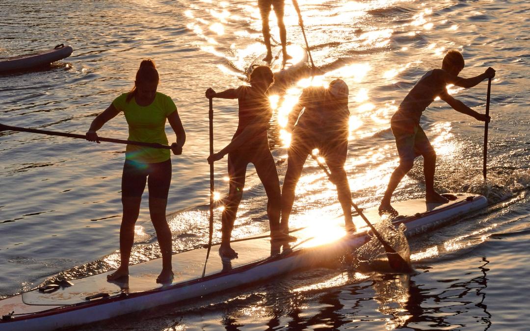 Young Adult Camping Friends Paddleboarding