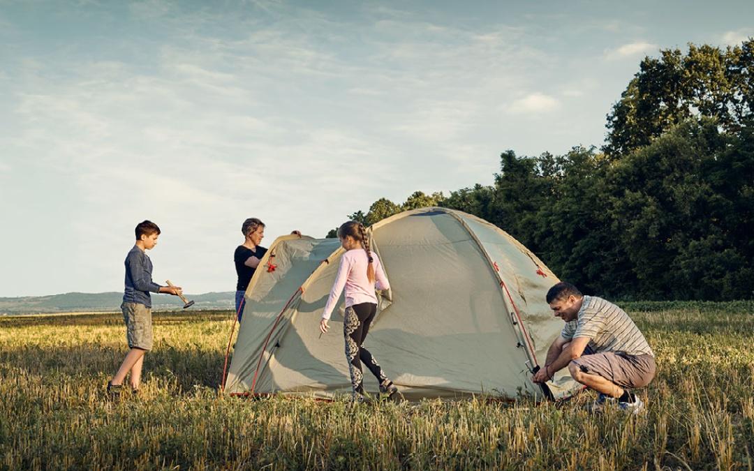 west of wells camping & glamping campsite view with family pitching a tent