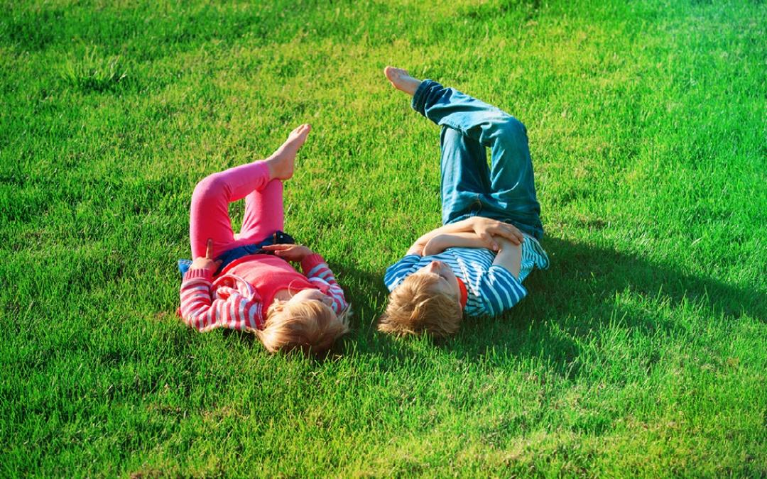 west of wells camping & glamping children relaxing on the grass