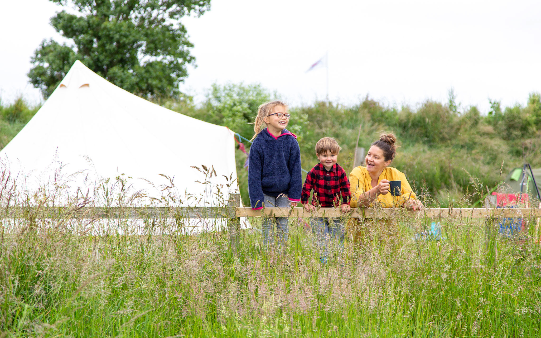 mYminiBreak, Hunstanton Glamping, familiy enjoying the meadow views while in their Glamping Bell Tent