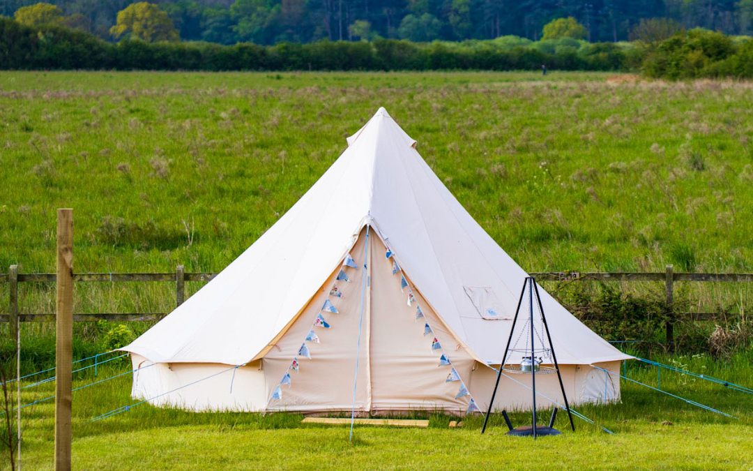 A blank canvas bell tent with meadow views here at Hunstanton Glamping