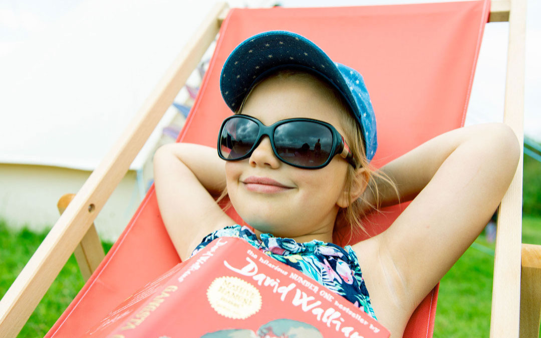 child relaxing on a deck chair