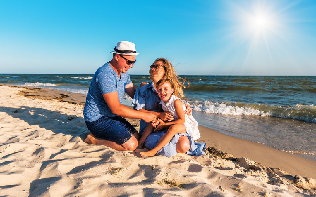 family down by the sea on the beach