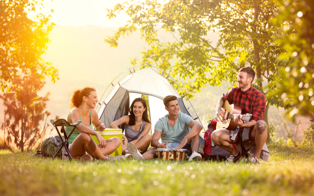 friends gathered outside a tent