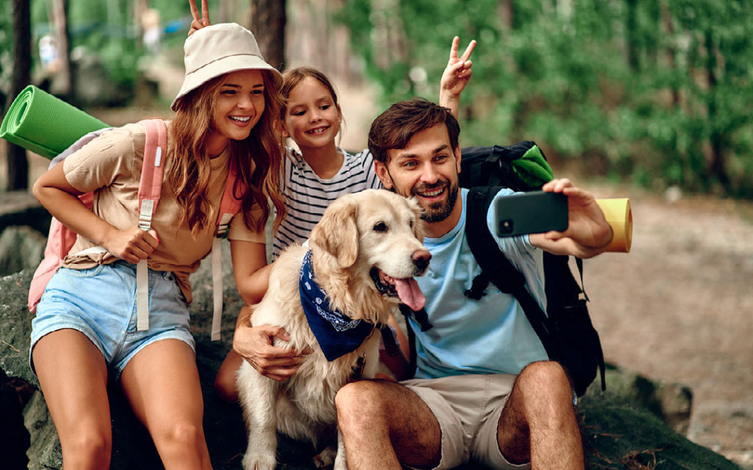 family with kid and a dog on a hike in a forest