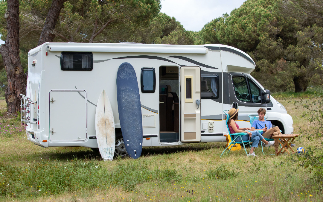 watersports and surfing equipment outside a motorhome