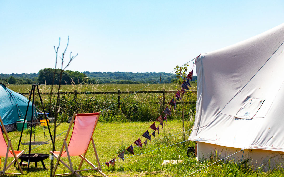 fire pit and chairs outside a bell tent