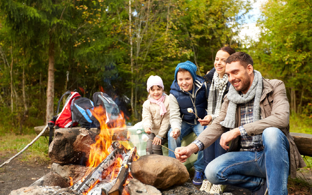 family roasting marshmallows campfire fire pit