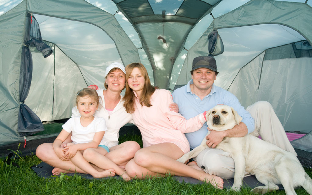 family in tent with a dog