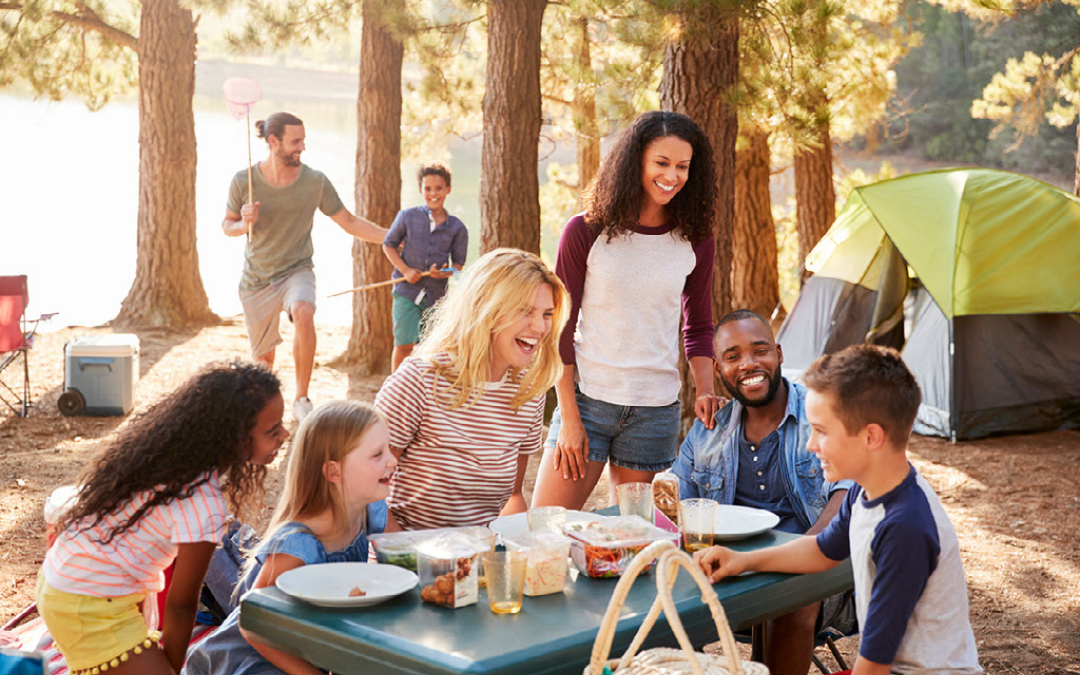large group laughing over a picnic