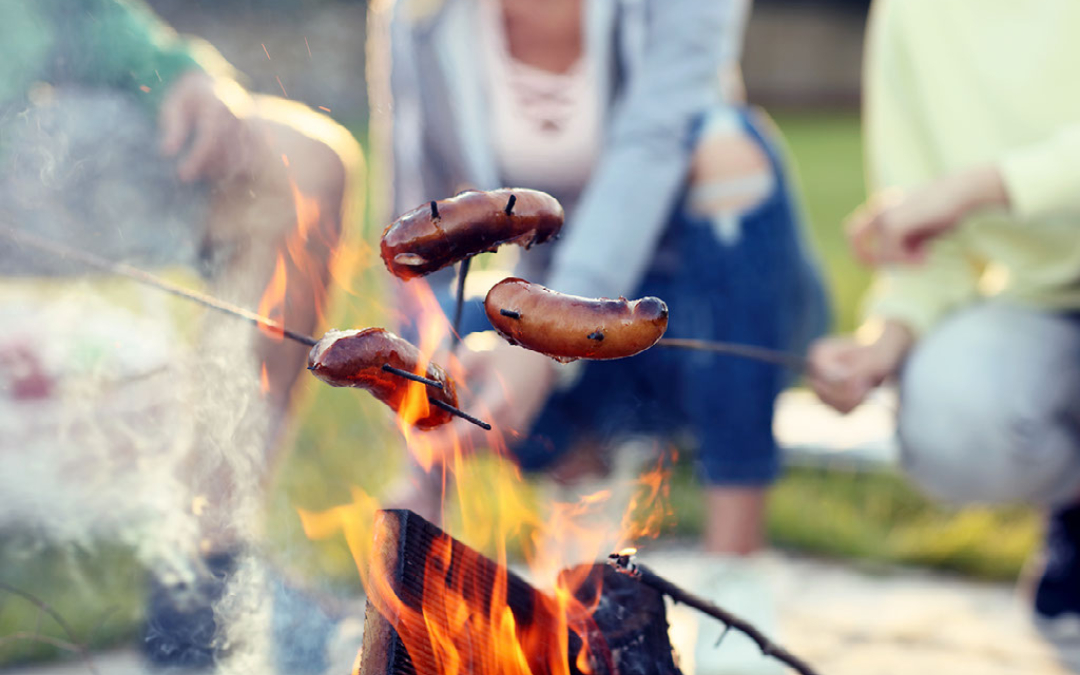 sausages cooking on an open fire