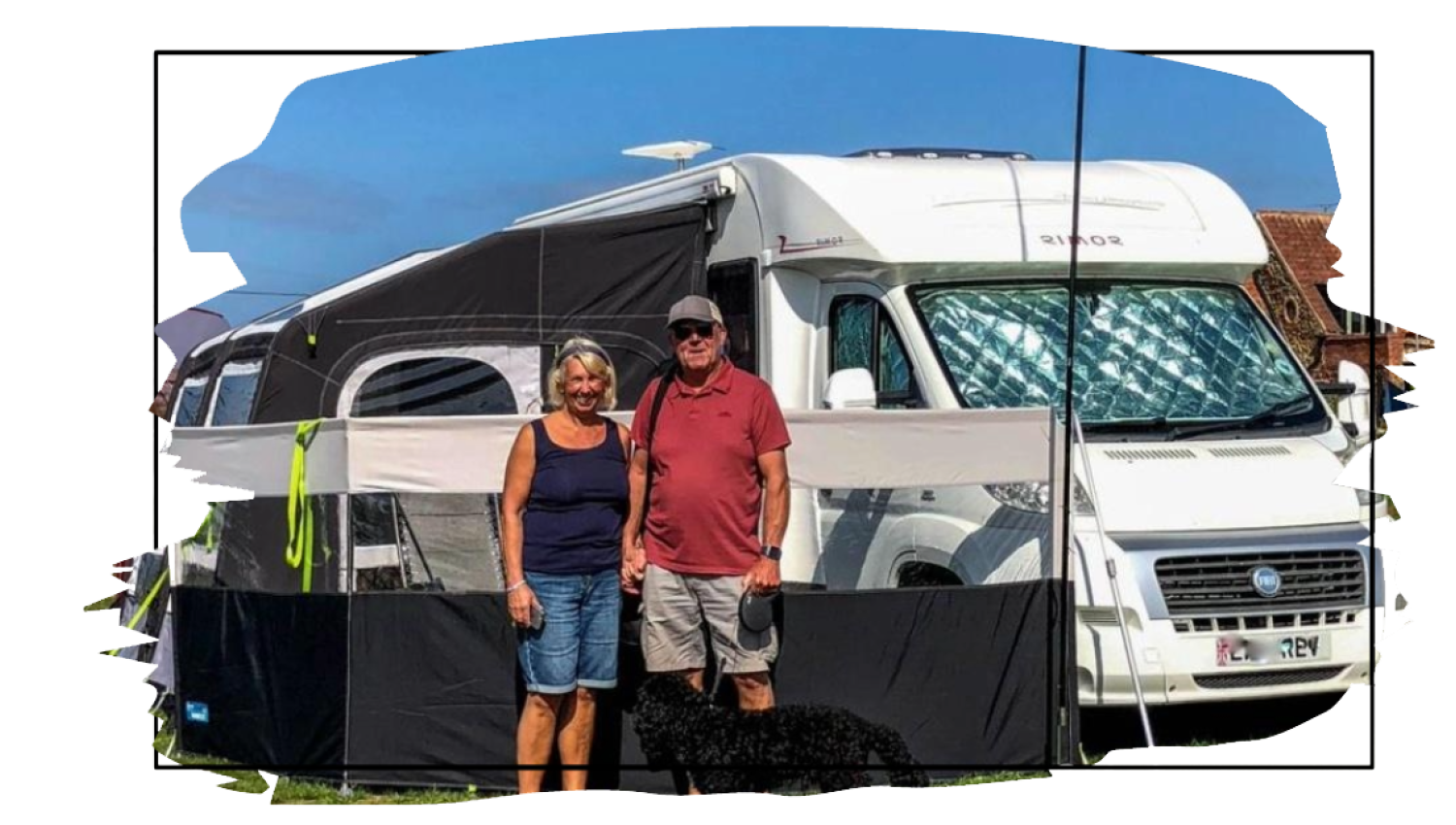 a couple with their dog standing in front of a motorhome with awning in Hunstanton