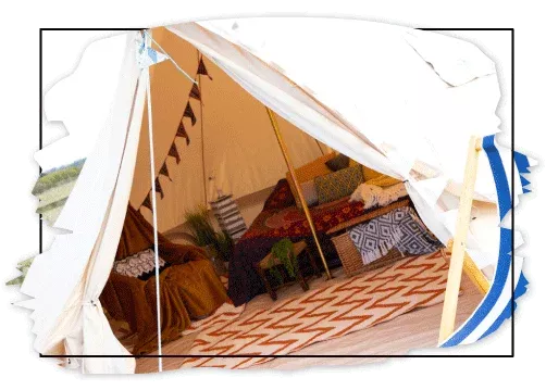 Hunstanton Glamping Bell tent, a view inside with a comfy double bed and cosy textiles