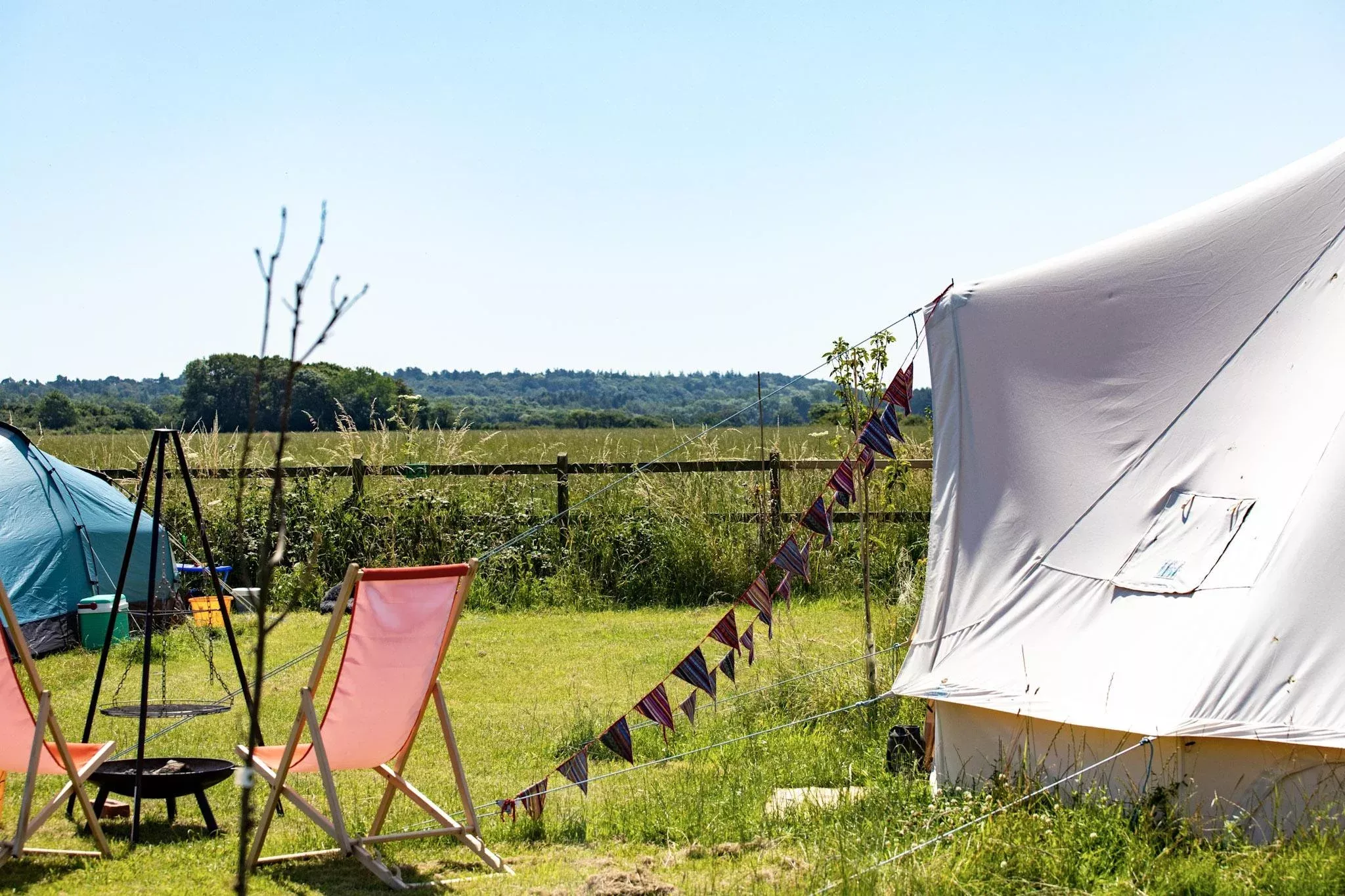 Bell tents in Norfolk with outdoor seating and a fire pit