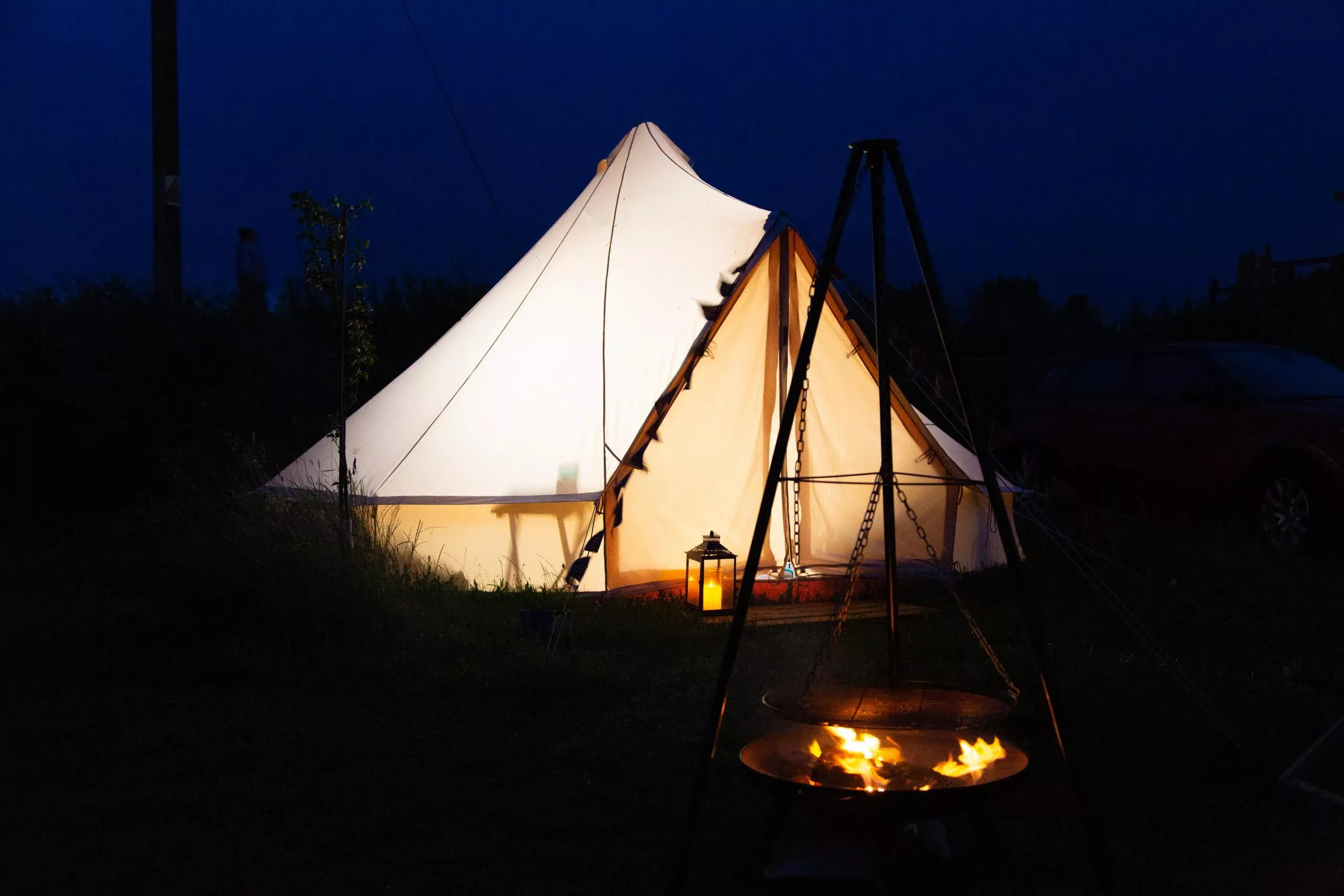Glamping Yurt at night with a lit campfire