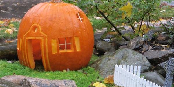 A pumpkin carved into a house for Halloween