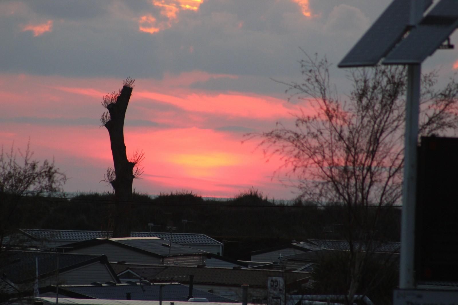 Pink sunset over holiday homes on the Norfolk Coast