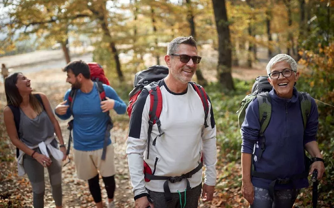 a group of people hiking in a forest environment