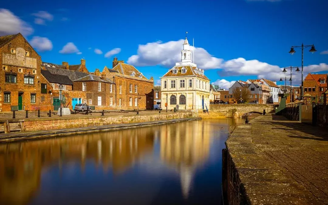 the customs house in kings lynn on the side of the river ouse