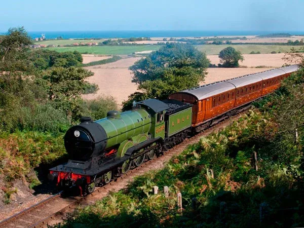 a steam train running through the north norfolk coast and countryside